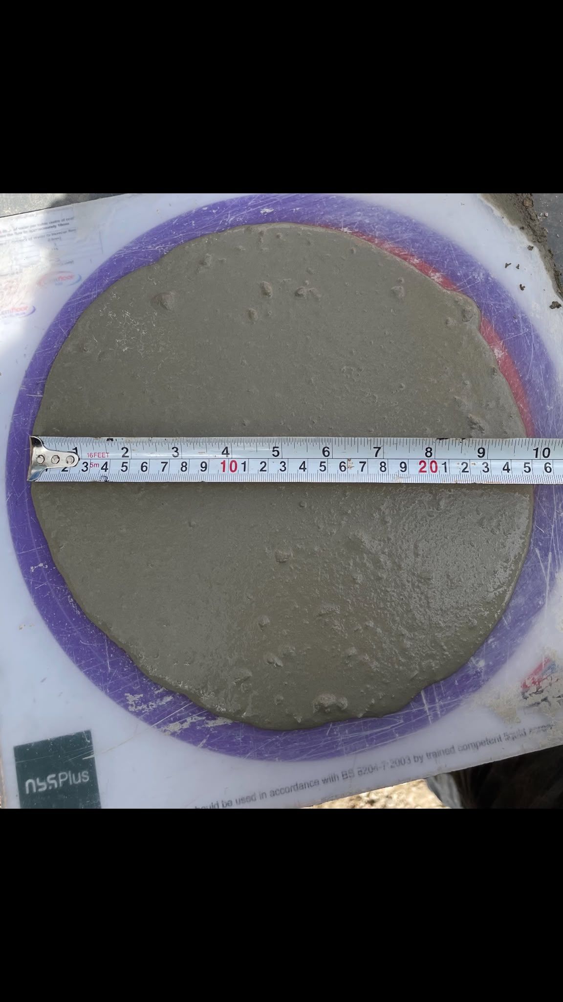 A flow-ring test of flowing screed measured with a rule before pumping