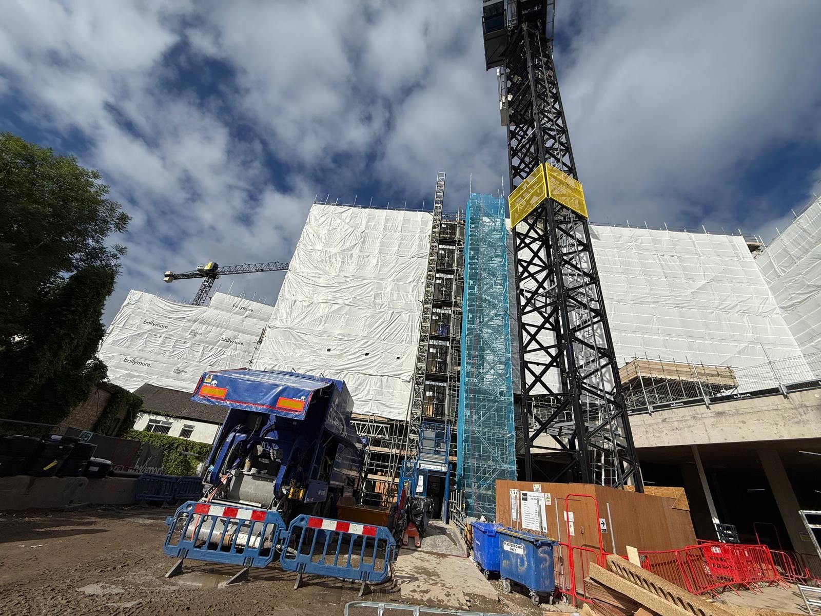 The Maverick at the foot of a scaffolded residential block with a tower crane at Brentford Lock Phase 2a