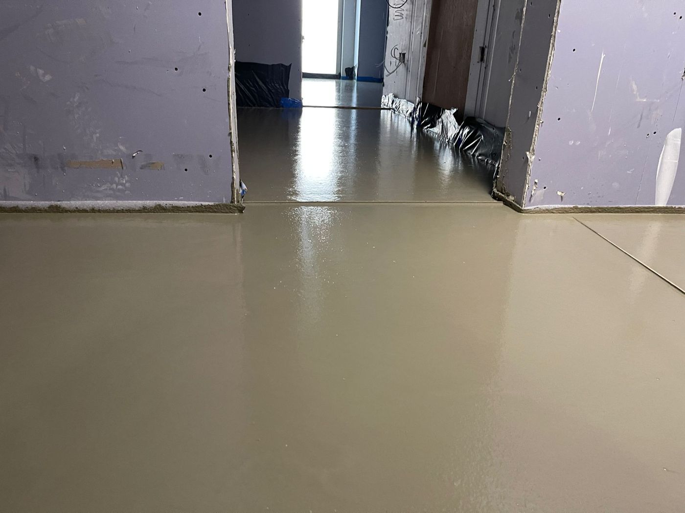 A long corridor with a smooth finished flowing screed floor
