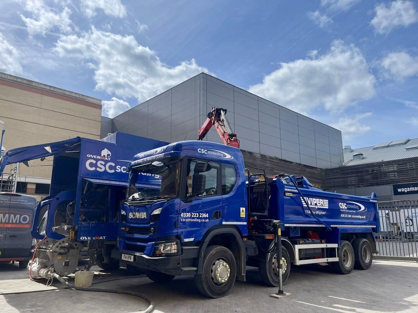 The CSC Maverick screed truck parked on a city-centre construction site, ready to batch flowing screed