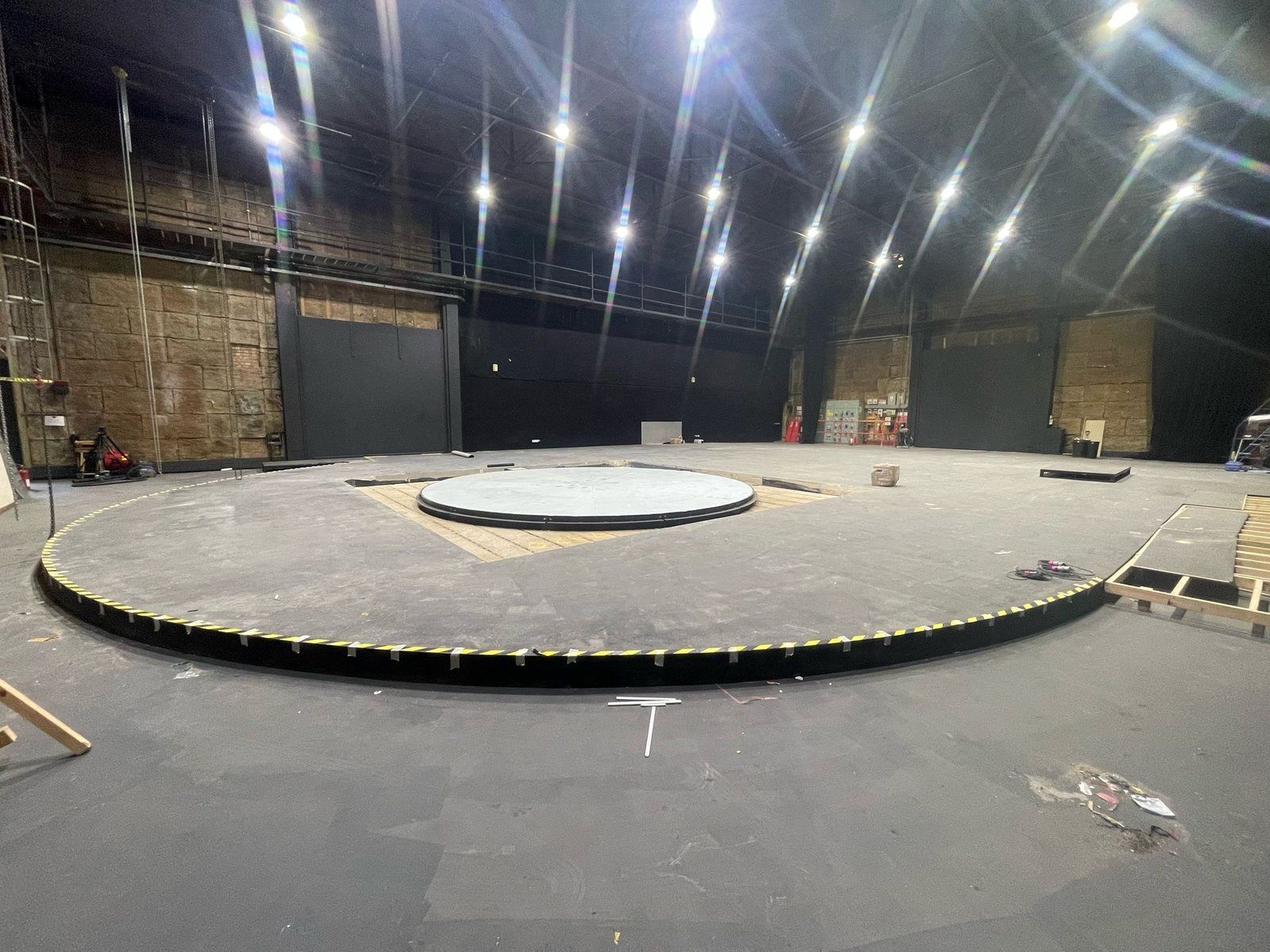 The finished circular flowing screed floor under studio lighting at Twickenham