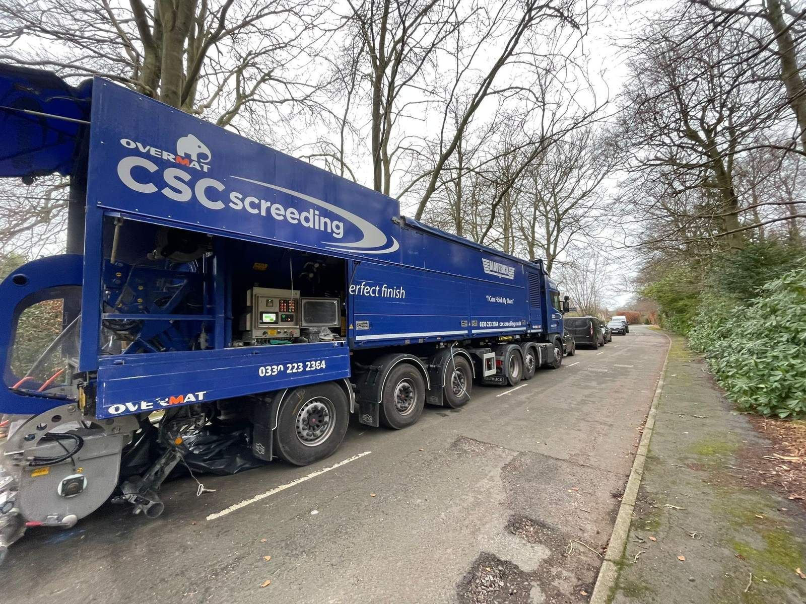 The Maverick parked on a tree-lined residential lane while pumping flowing screed