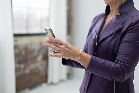 Woman in a purple jacket using a smartphone. Woman in a purple jacket using a smartphone.