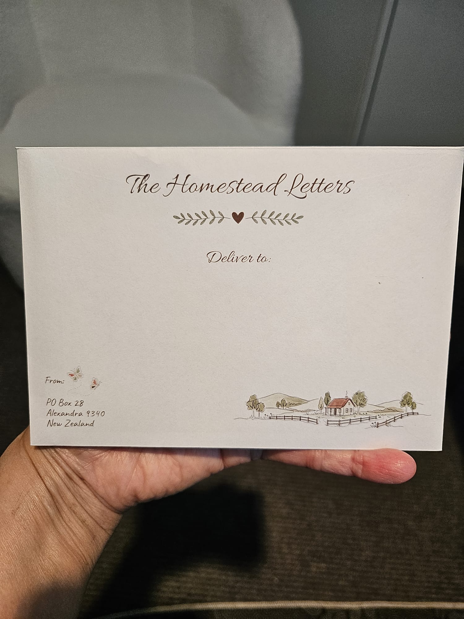 Hand holding an envelope showing what the homestead letter envelope looks like