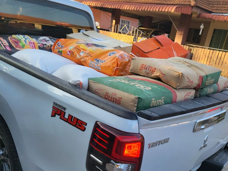 The back of a pickup truck loaded with bags of rice, dog food and animal supplies ready to be delivered to a remote rescue centre near Chiang Rai, Thailand, caring for around 130 dogs and more than 20 cats.