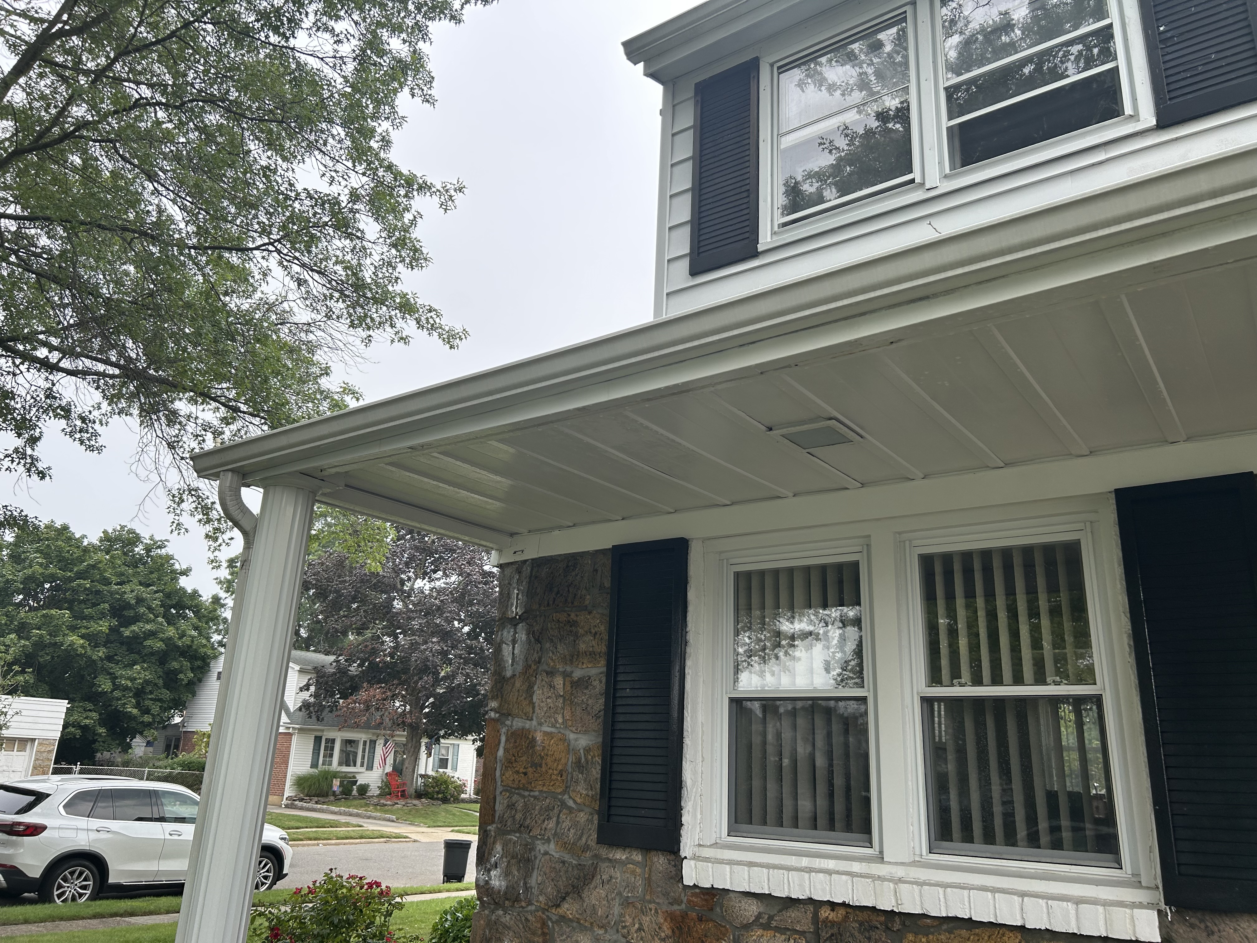 After: the same gutter run brightened back to a clean, even white.