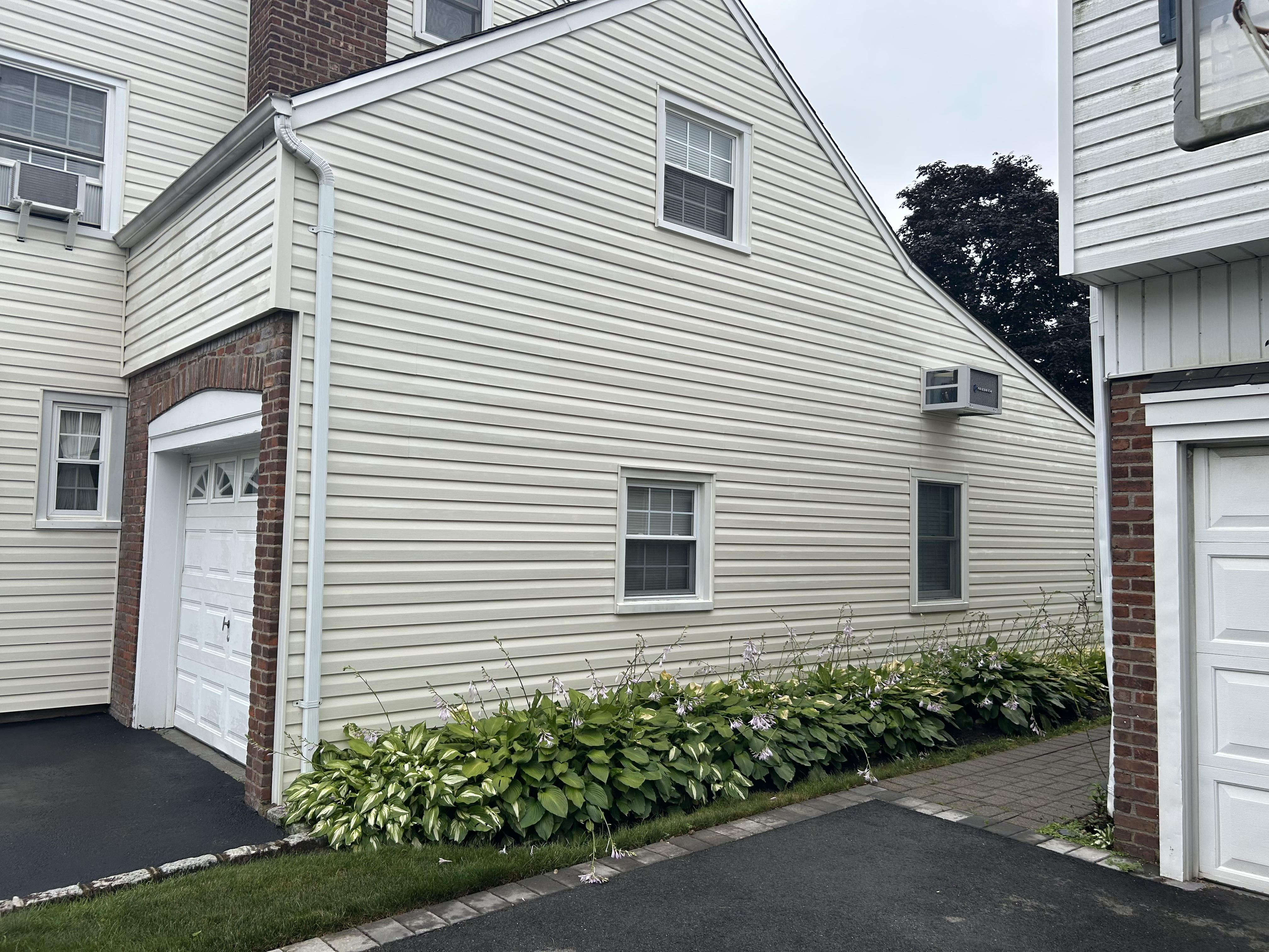 After: the same Garden City siding soft-washed back to clean.