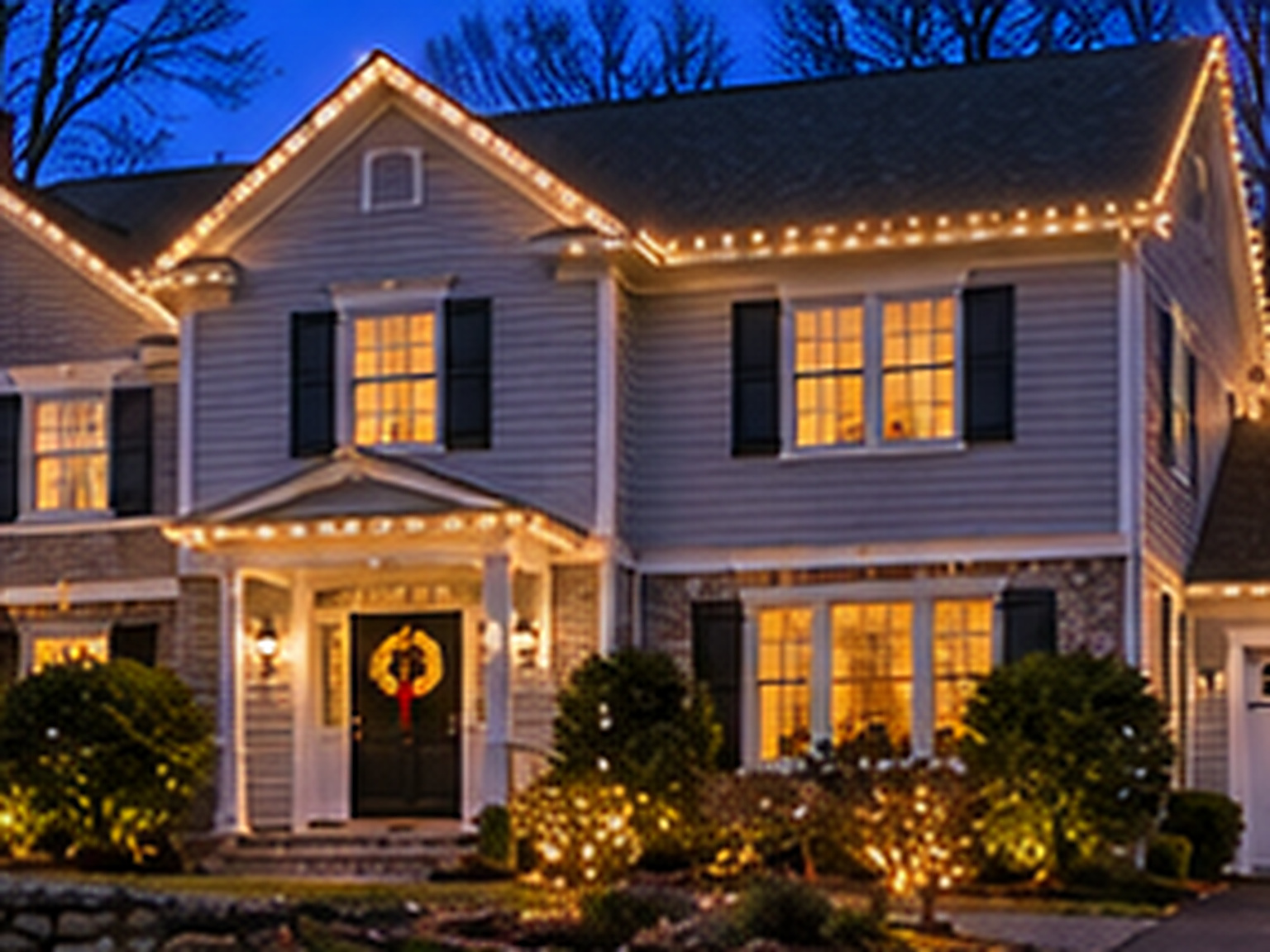 Home in Shelton, CT lit with warm white Christmas lights
