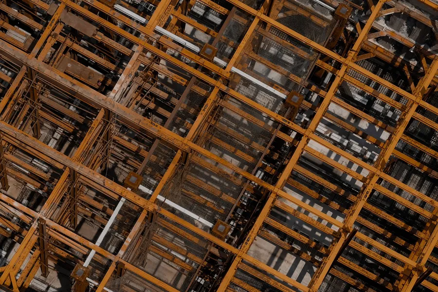 Grid of structural steel beams at a construction site, seen from above