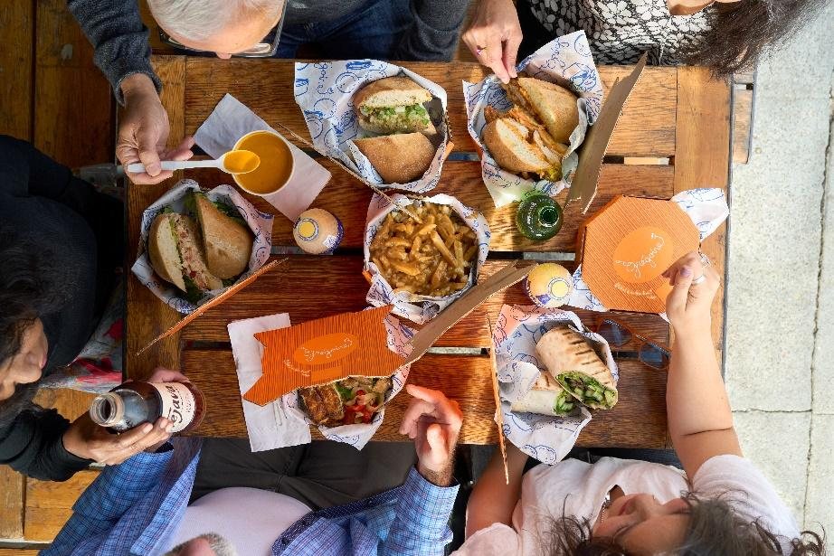 A table of Grégoire sandwiches, fries and sides ready to share