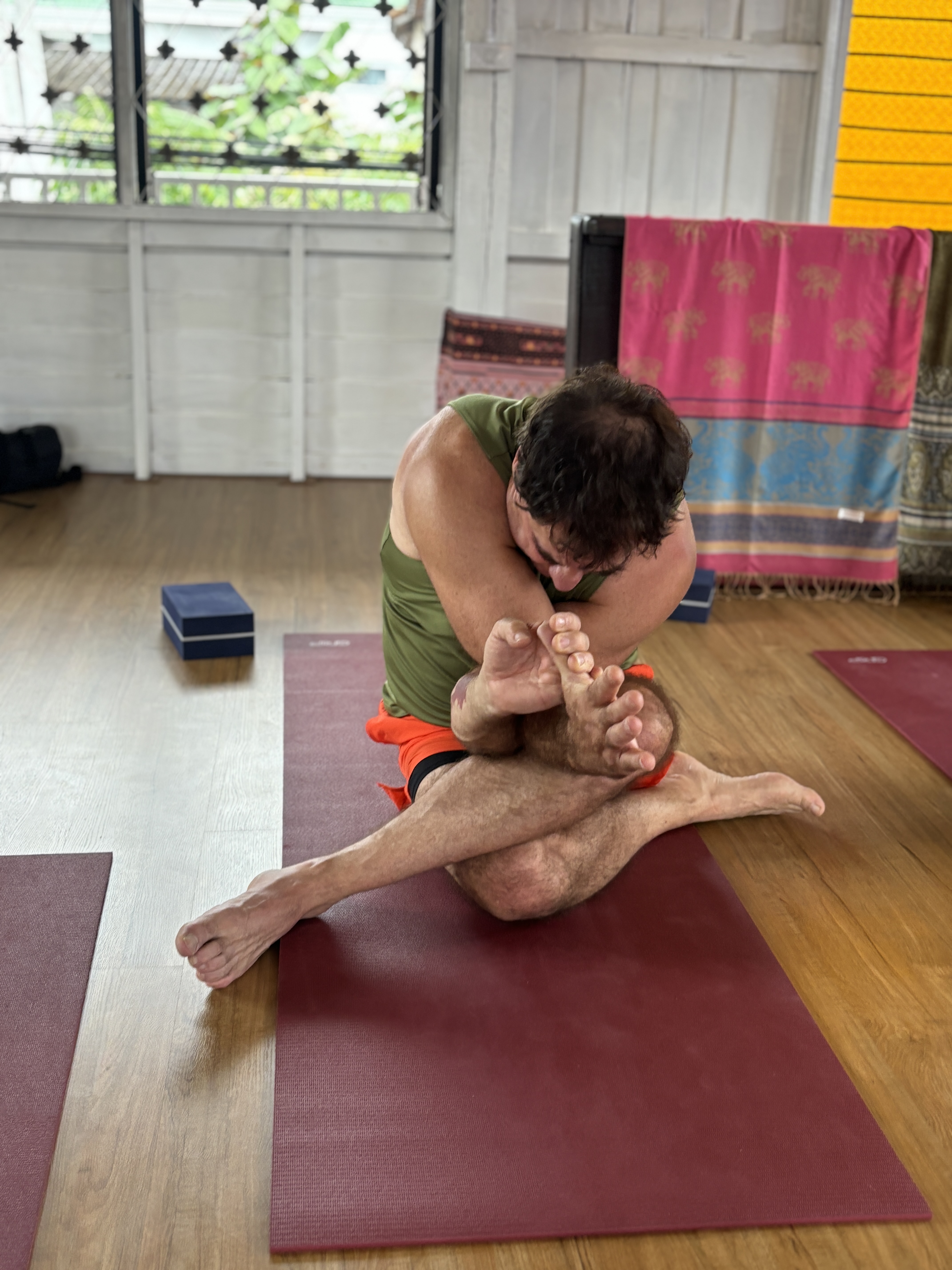 RepuBoostAI founder David Vincent in a seated yoga twist in Chiang Mai, Thailand