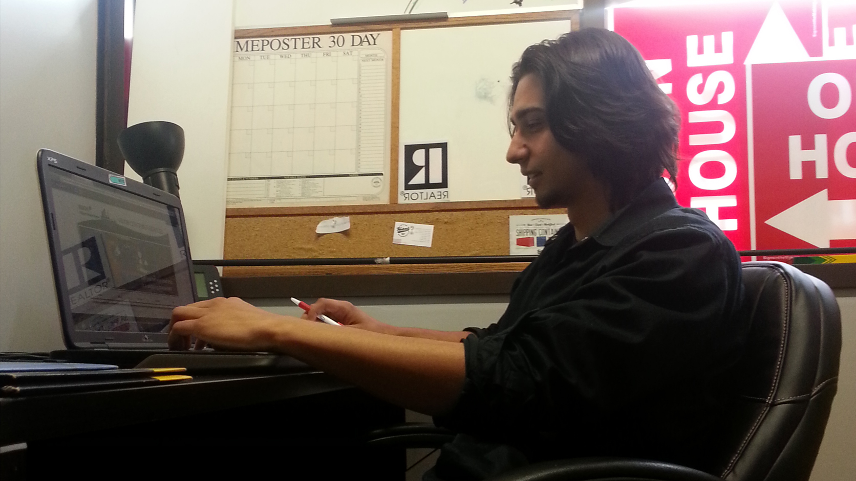 Johnny Pomykacz working at his first real estate client's office