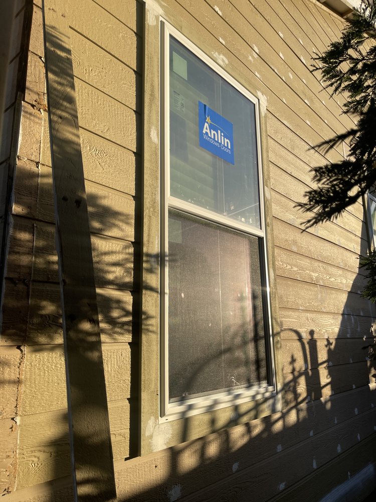 A newly installed window on the side of a house