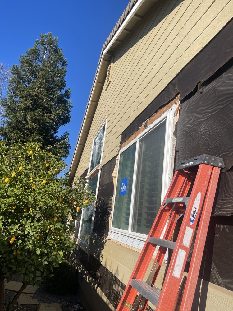 Windows mid-install with weather barrier and flashing exposed