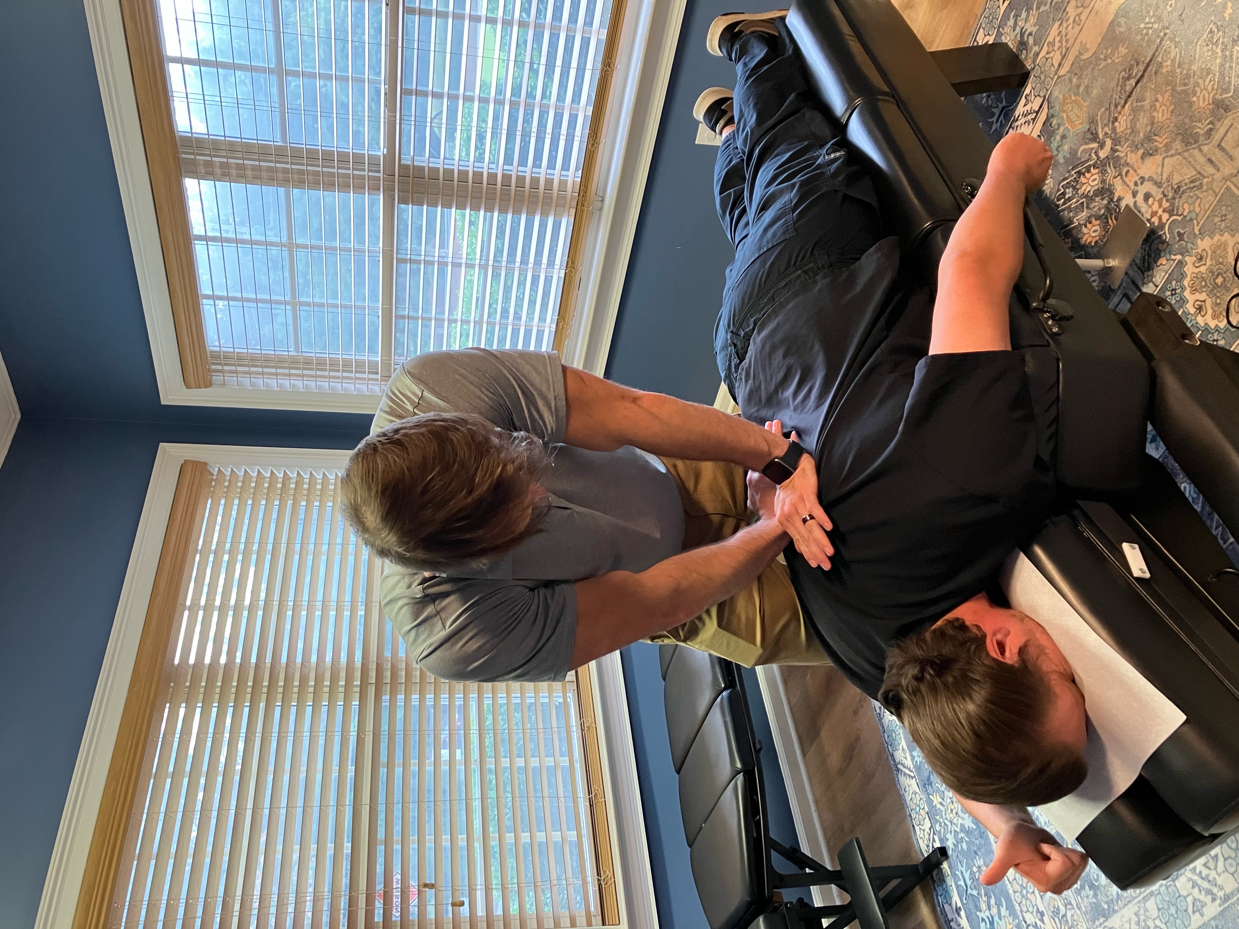 Dr. Morgan Stauffer performing a chiropractic adjustment in Woodstock, GA