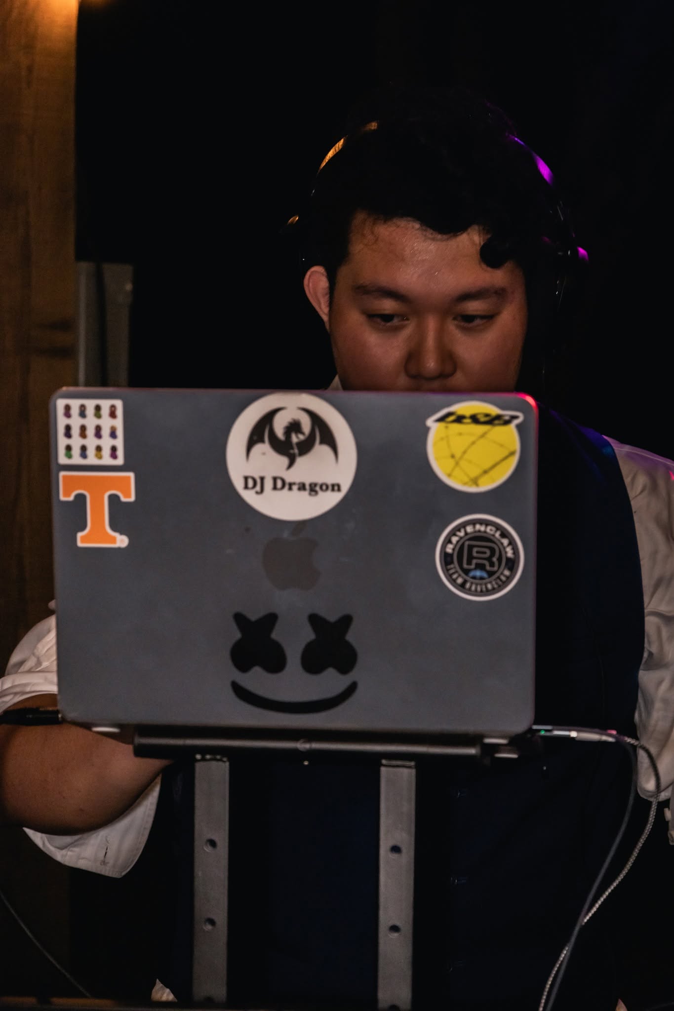 DJ Dragon mixing a wedding set behind his laptop with the DJ Dragon sticker