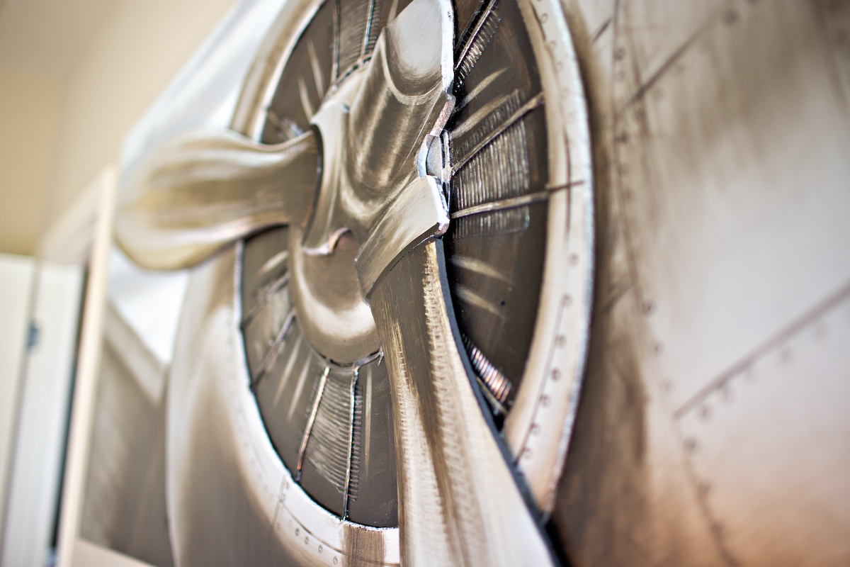 Metal wall art piece, designed to be the front of an airplane.