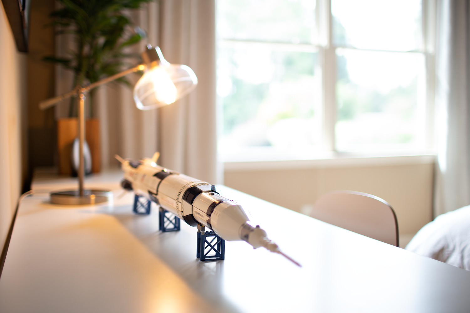 Model spaceship atop a white desk.