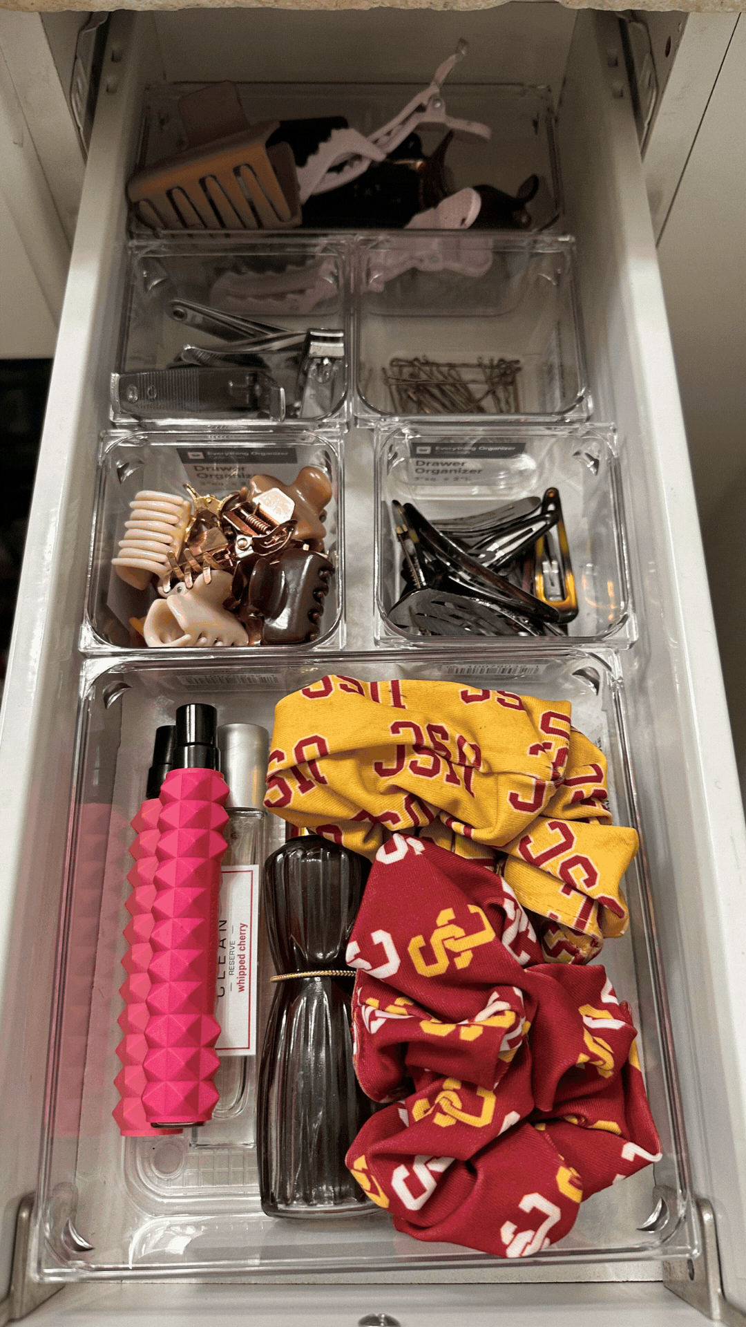  Closet with organized shelves, folded towels, and suitcases.