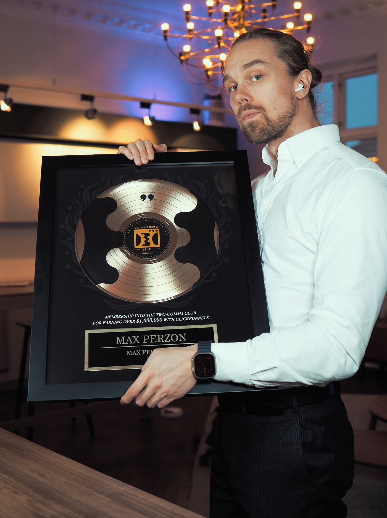 Max holding the ClickFunnels Two Comma Club award