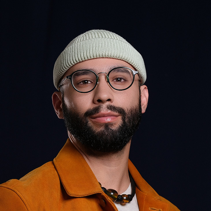 Man in a knit beanie and glasses