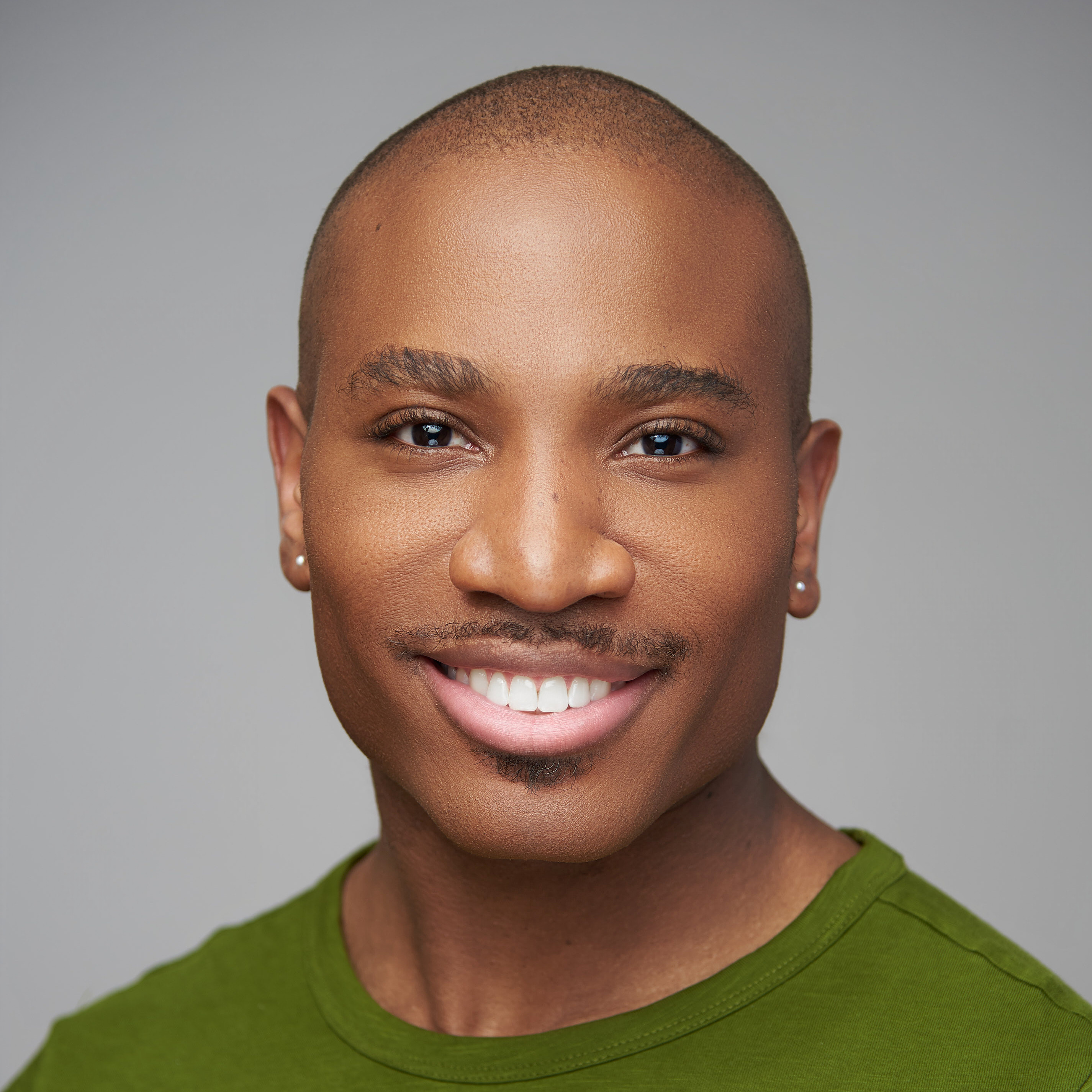 Smiling man on a green backdrop
