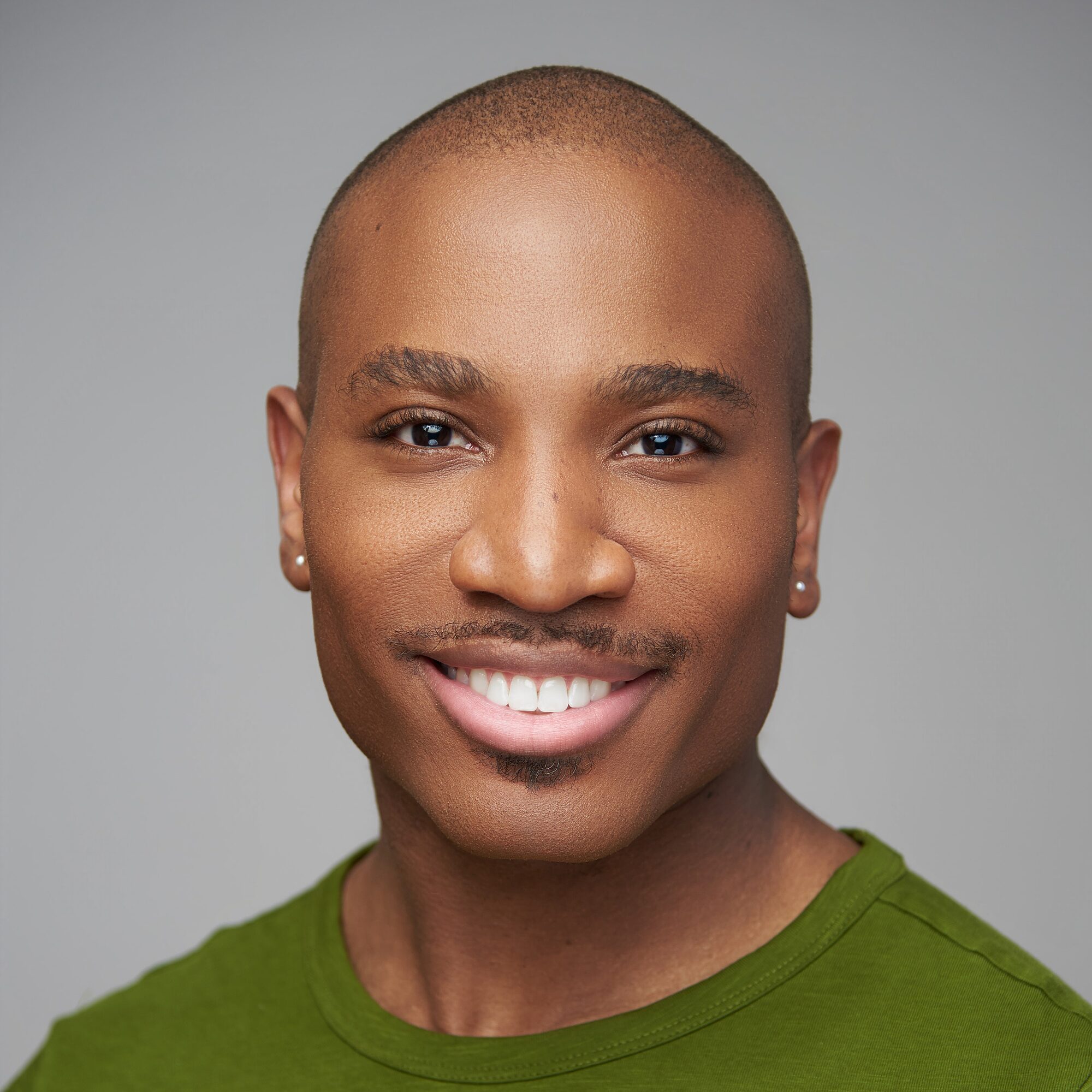 Smiling man on a green backdrop