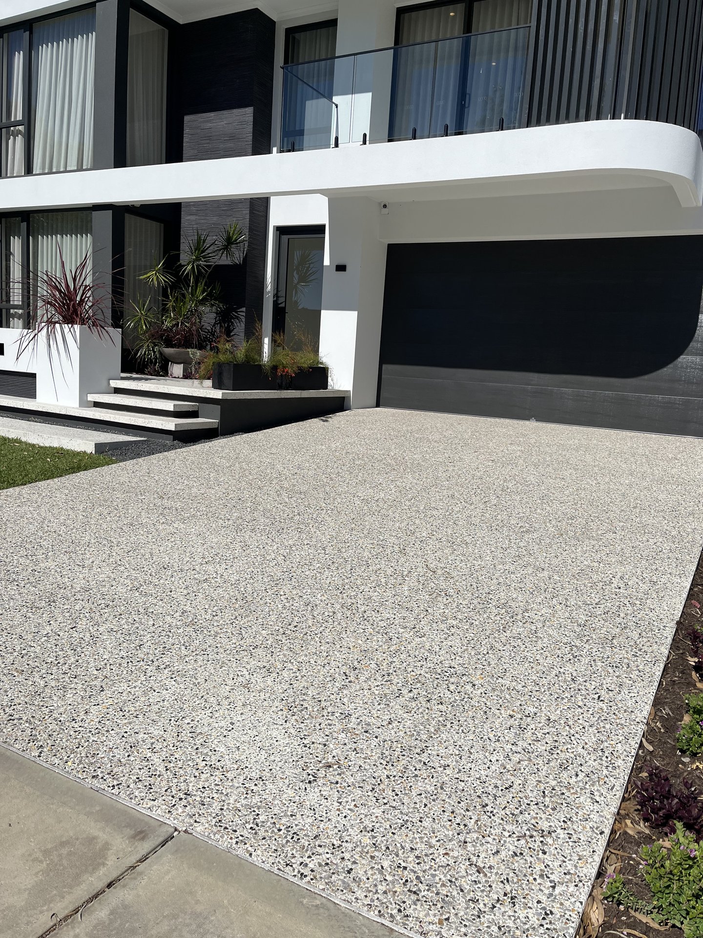 Modern home with exposed aggregate driveway