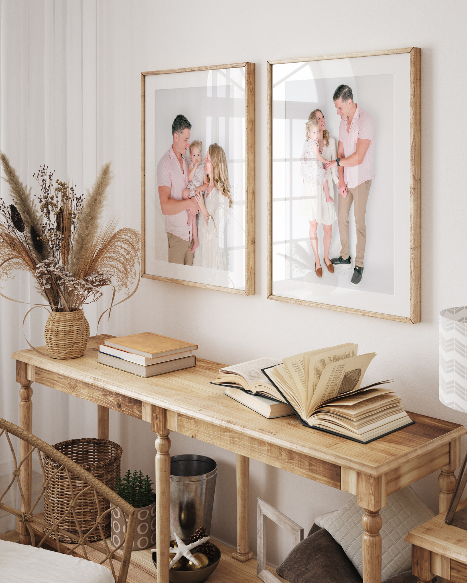 A mockup of an entry table with neutral decor. Above the table are two framed prints featuring images from a studio family session.