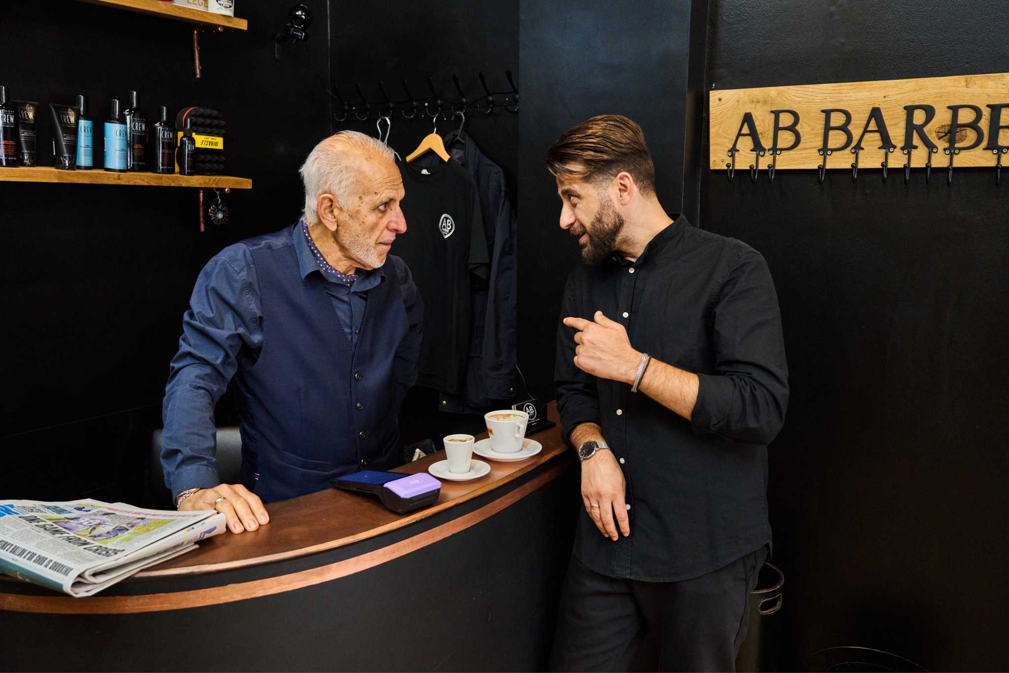 AB Barbers founder talking to staff member