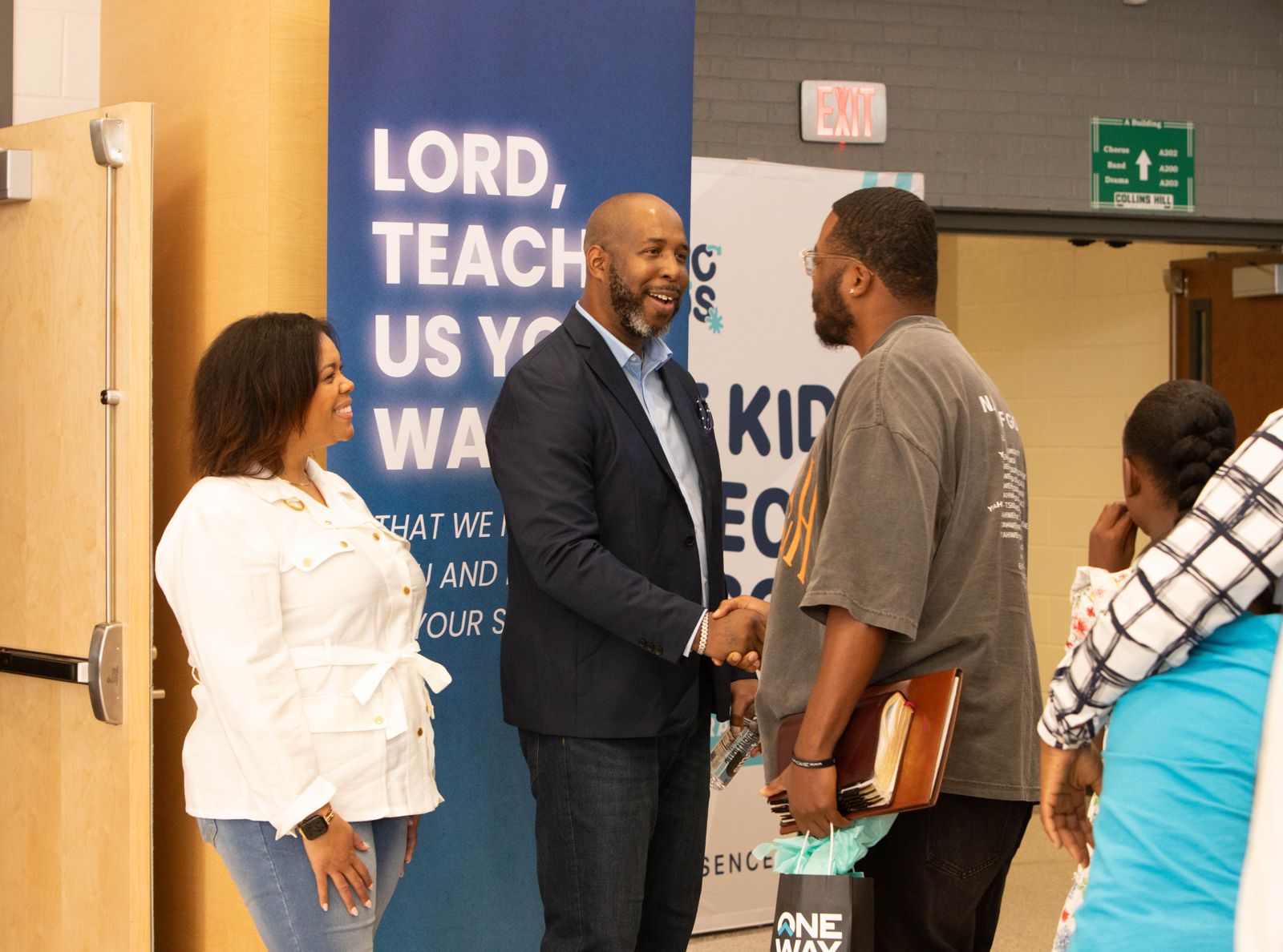 Pastors greeting a first-time guest at the door