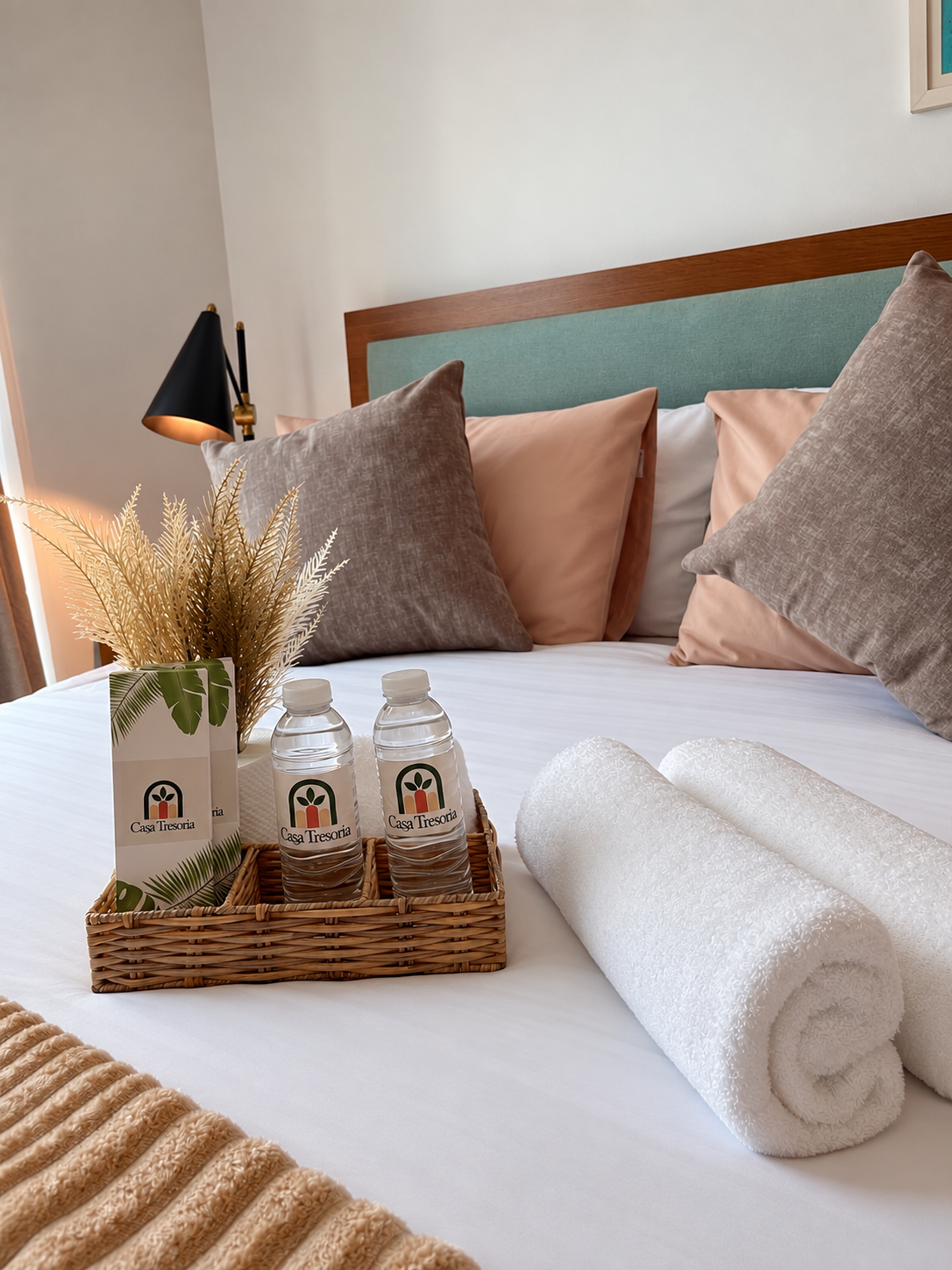 Casa Tresoria welcome basket with bottled water and rolled towels
