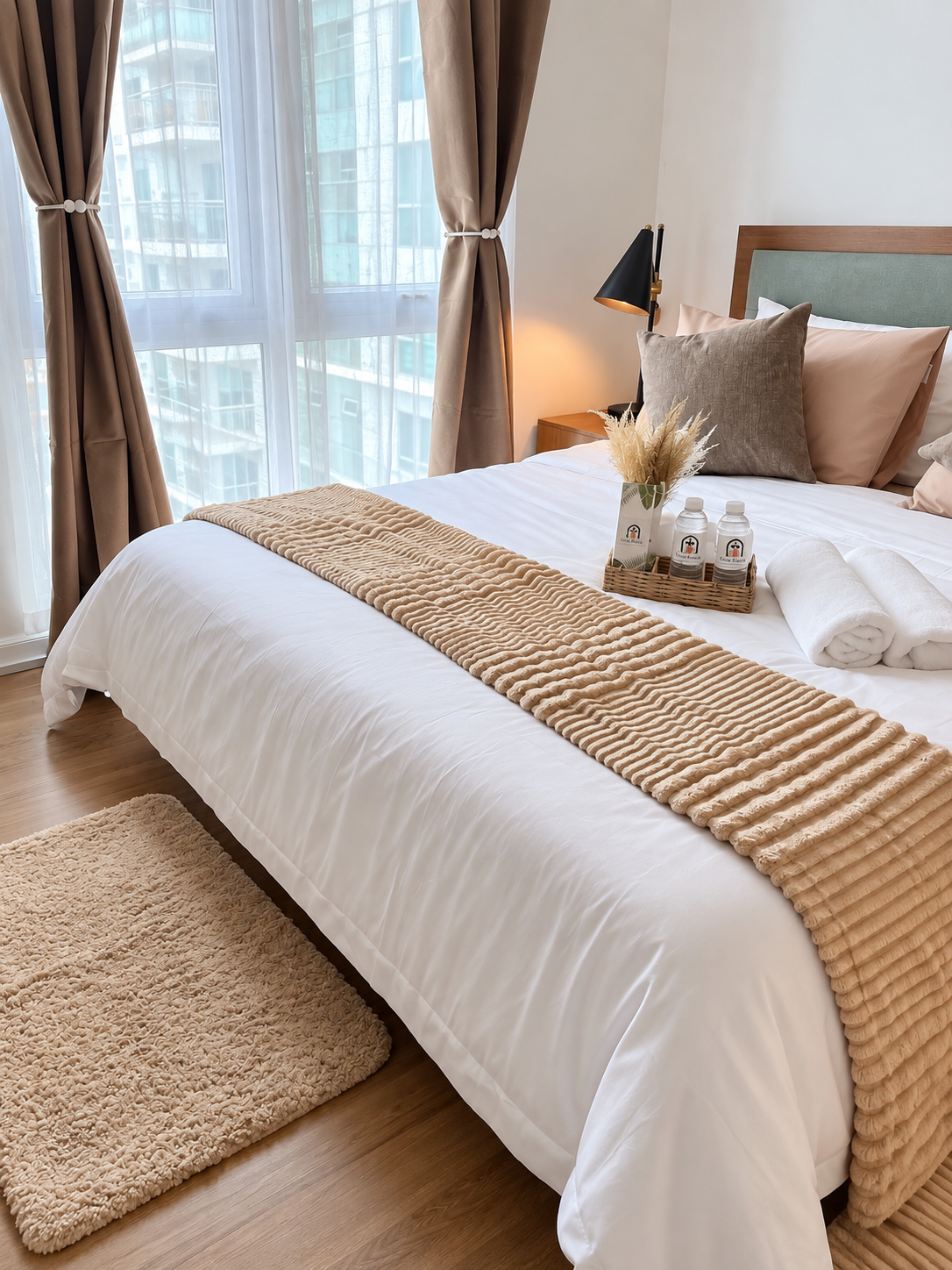 Casa Tresoria queen bed with window, bedside lamp, fresh towels, and welcome basket