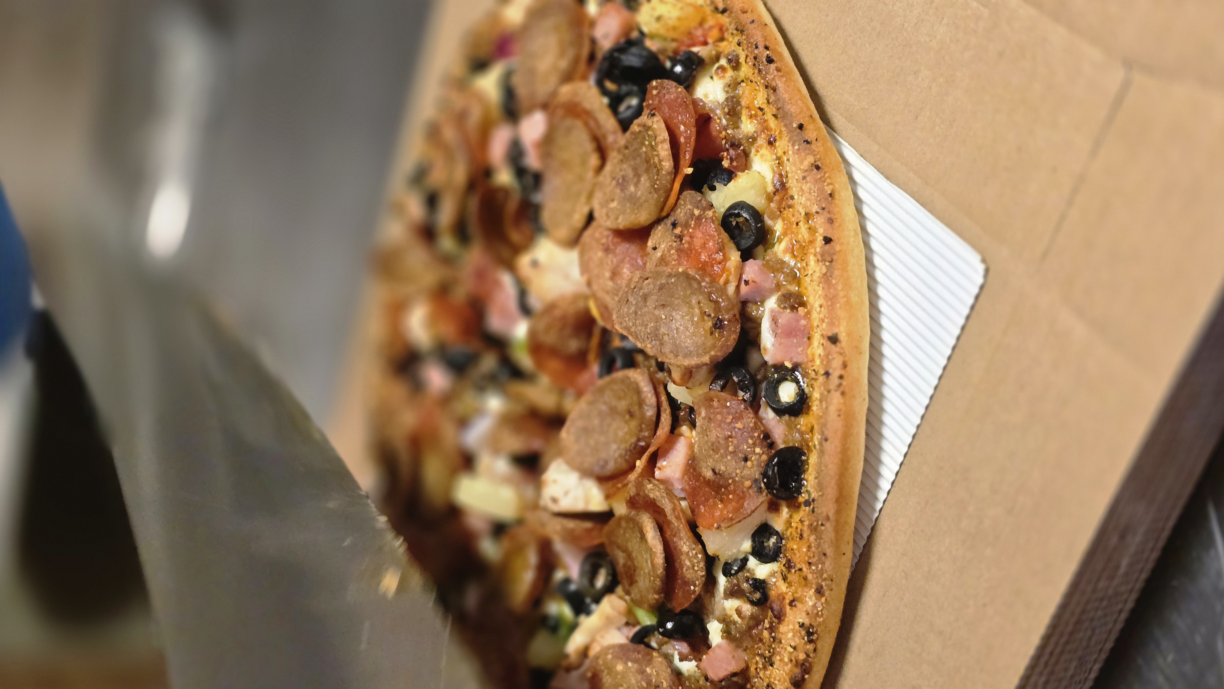Delicious generously topped pizza with cheese pull