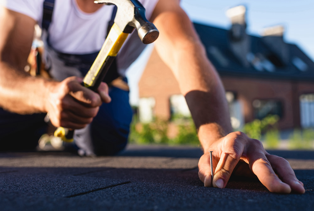 roofer repairing roof