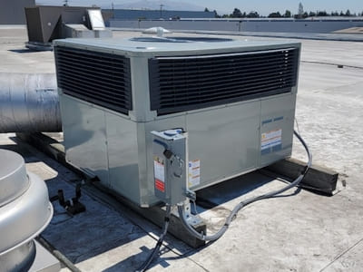 Rooftop HVAC unit installed for a commercial building, maintained for consistent and efficient cooling.