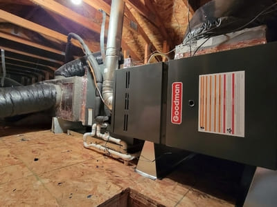 Goodman HVAC system installed in the attic of a home, designed for efficient heating and cooling distribution through ductwork.