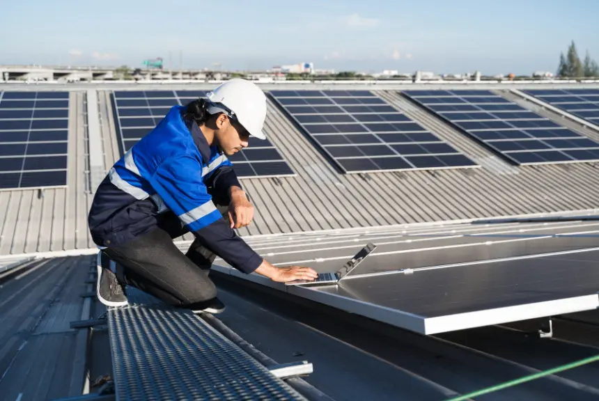 Engineer on rooftop with solar panels