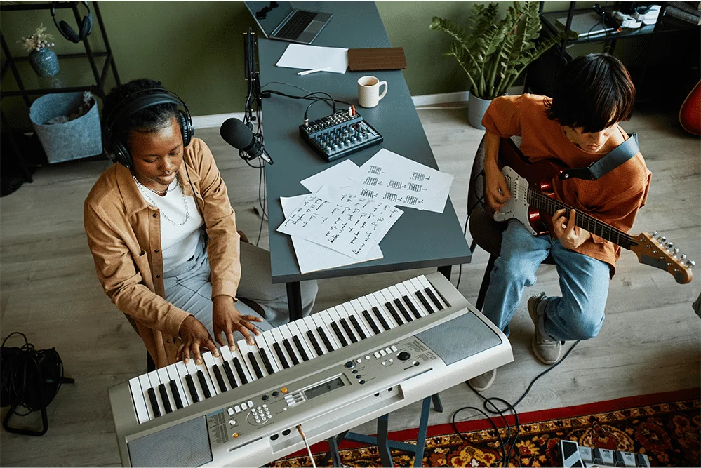 Two individuals playing music at piano Two individuals playing music at piano