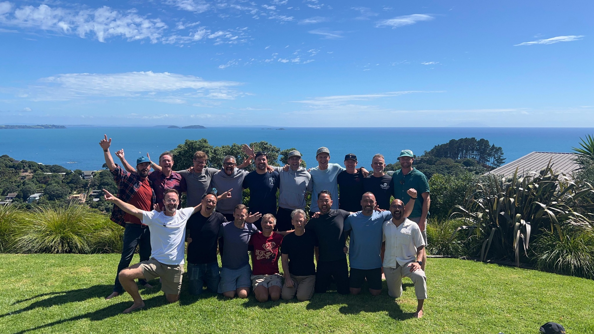 Men together on a hillside overlooking the ocean at a previous MELD retreat