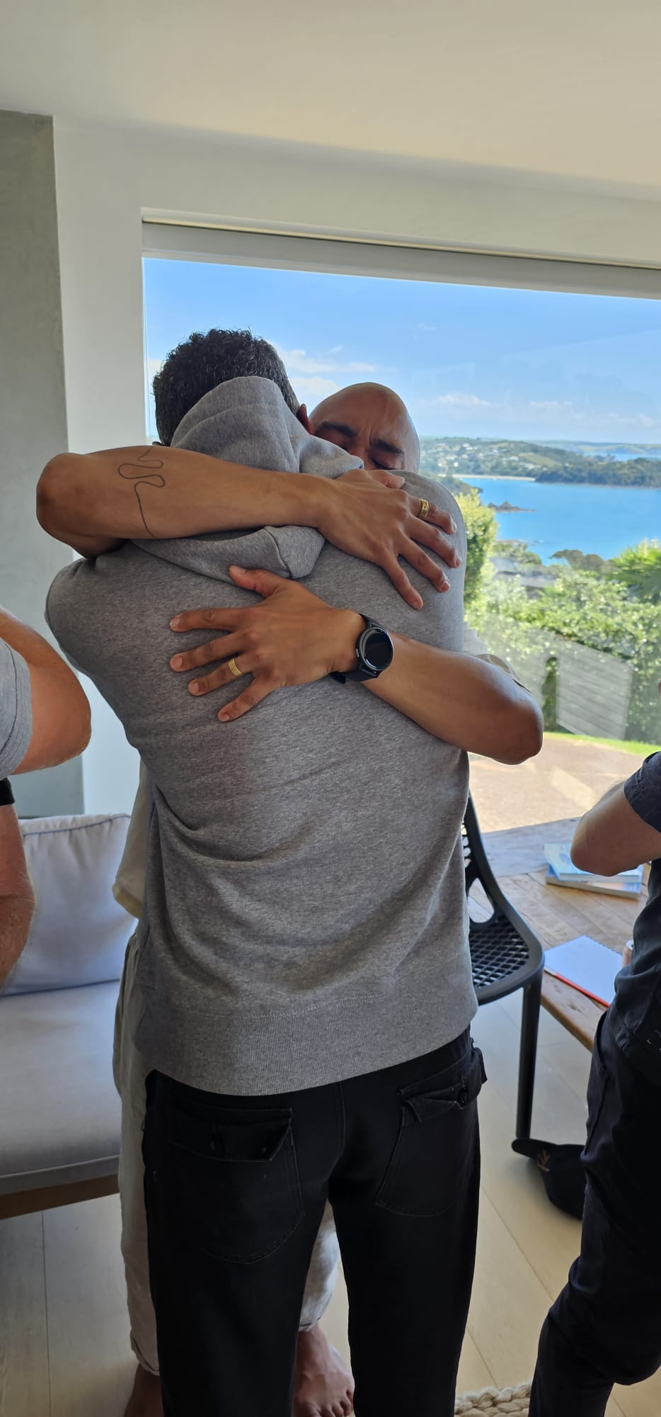 Two men embracing at a previous gathering