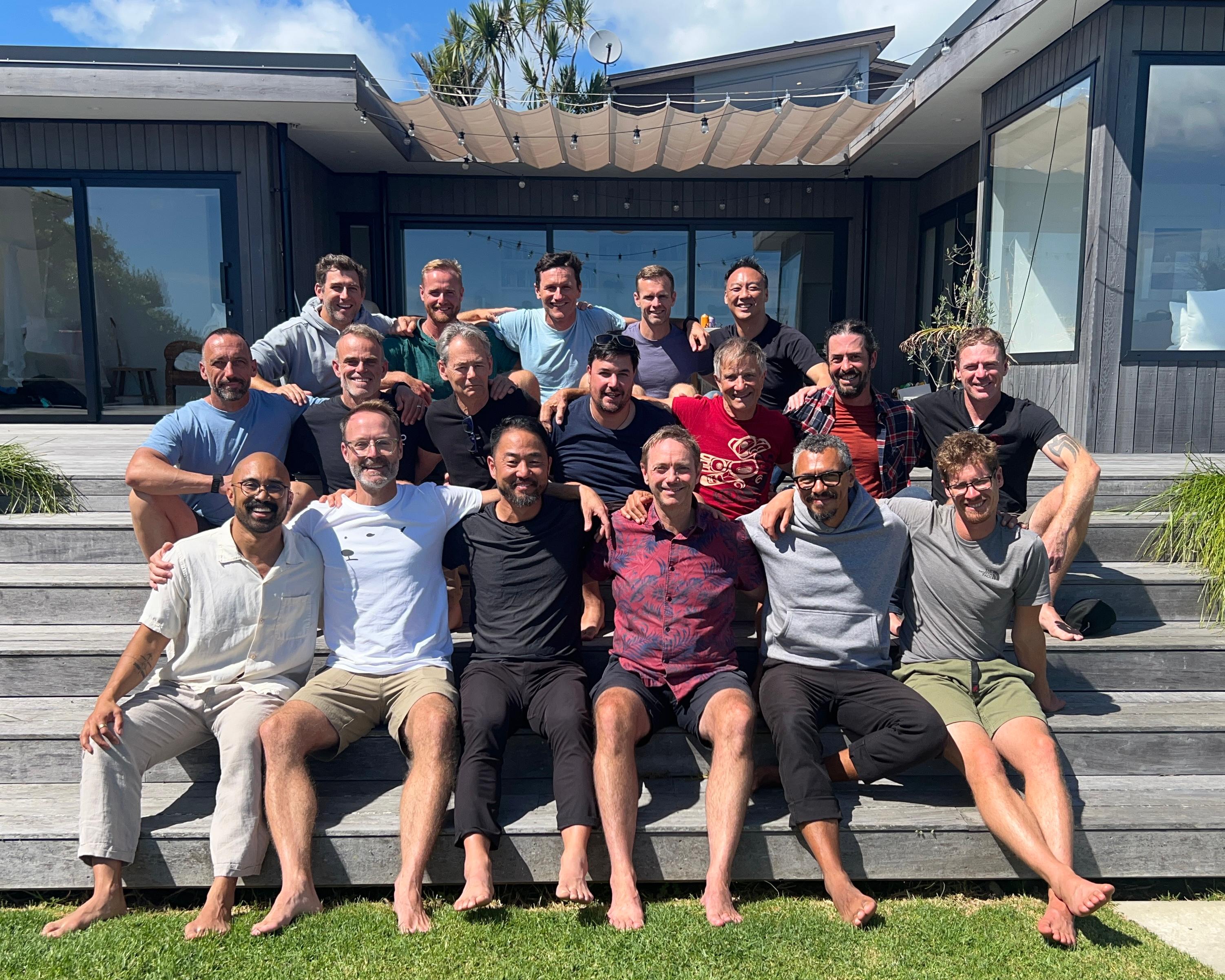 A group of men together on the steps at a previous retreat