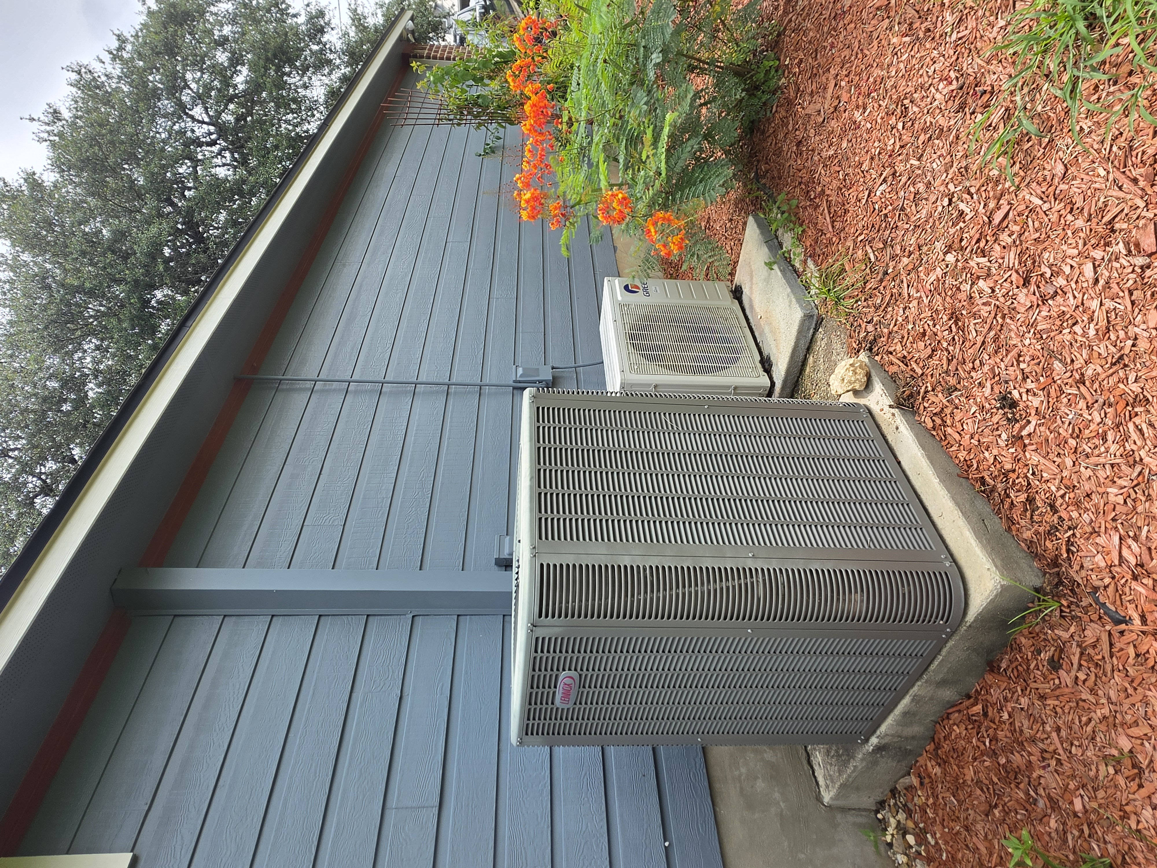 Residential air conditioning condenser unit at a Texas home serviced by Competition A/C & Heat