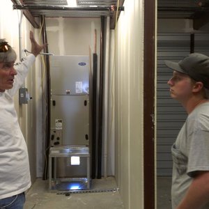 Competition A/C & Heat technicians servicing a furnace and heating system in Texas