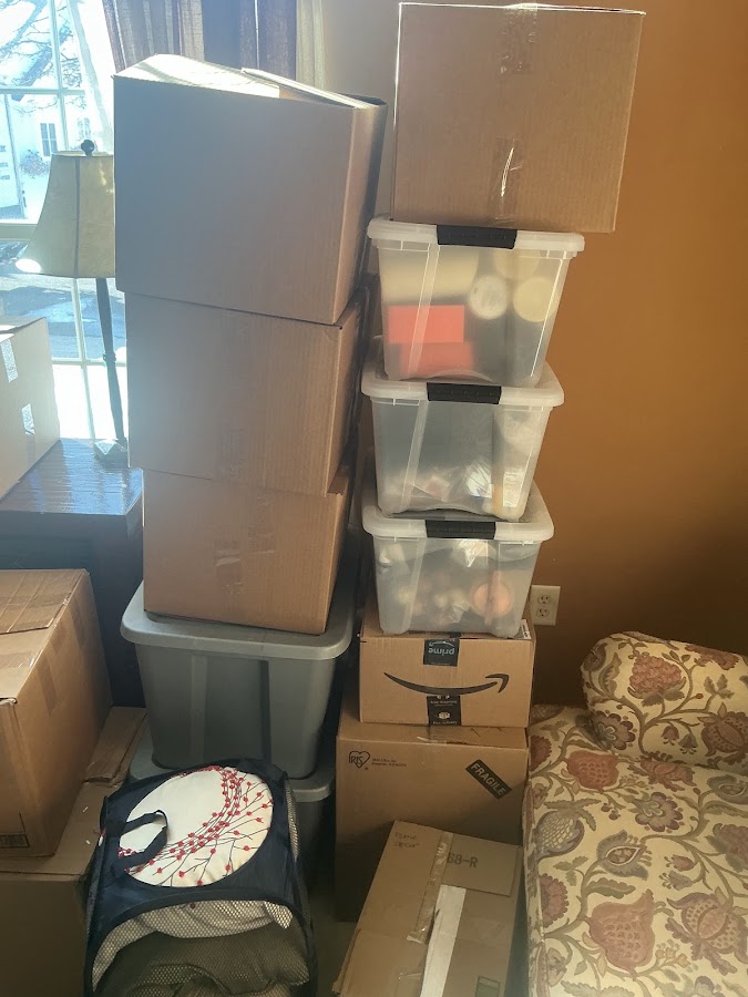 Cardboard moving boxes stacked next to clear plastic storage bins, ready for moving day in Burlington County NJ