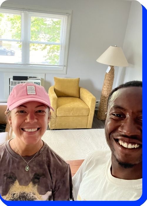 Smiling customers in a bright living room after a successful move with Keep It Moving Services
