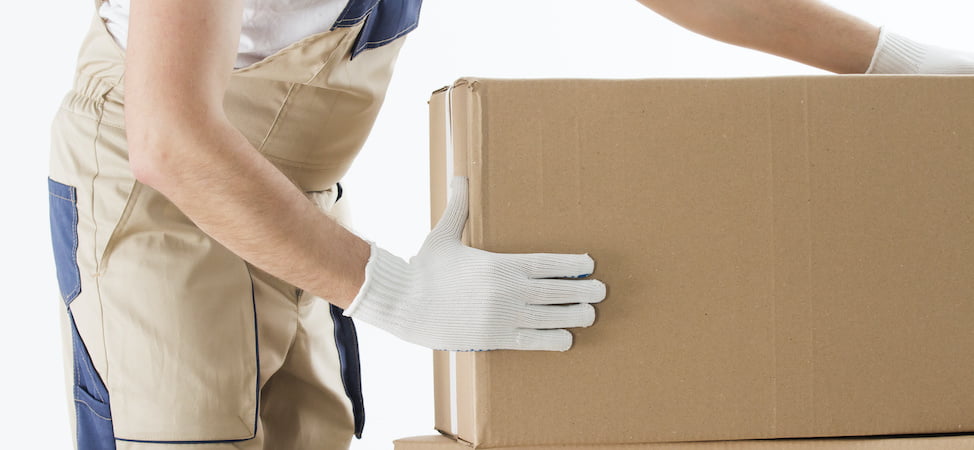 KIMS crew member carrying a cardboard box of packing supplies during a Burlington County move
