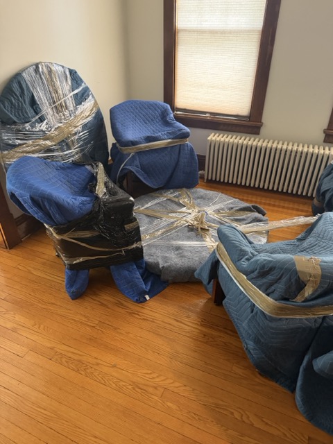 Keep It Moving Services crew wrapping living room furniture ahead of a NJ move-out