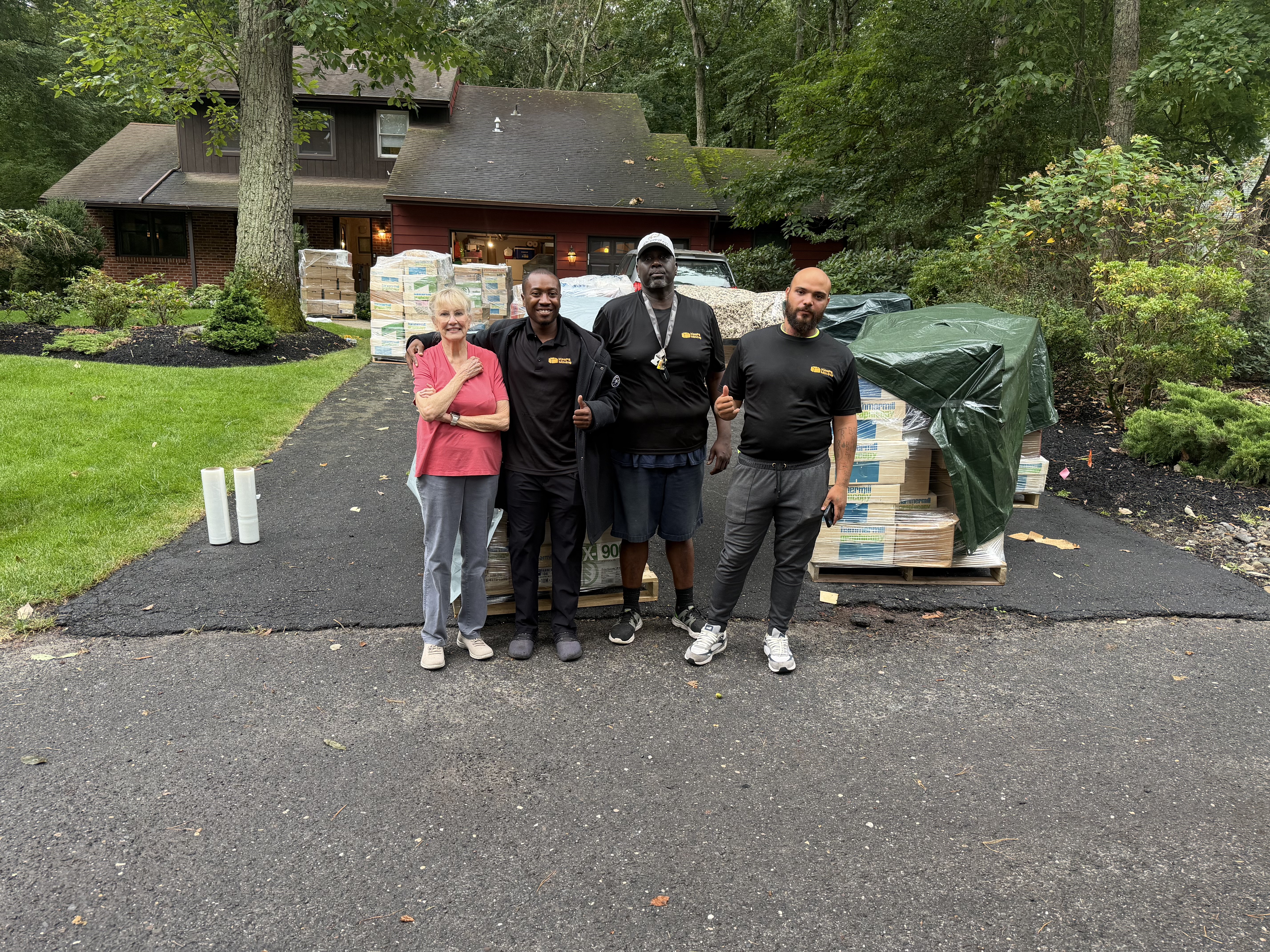 Professional movers resting inside a clean moving trailer during a residential relocation in Toms River, New Jersey, surrounded by secured furniture and moving equipment.