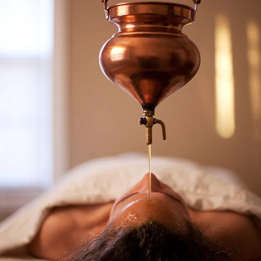Shirodhara treatment at Sandali Ayurvedic Wellness Centre - warm oil poured from a copper vessel onto the forehead